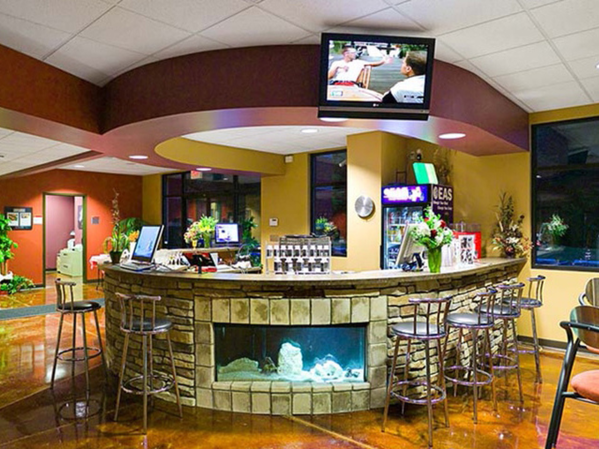 a bar with a tv and a fireplace